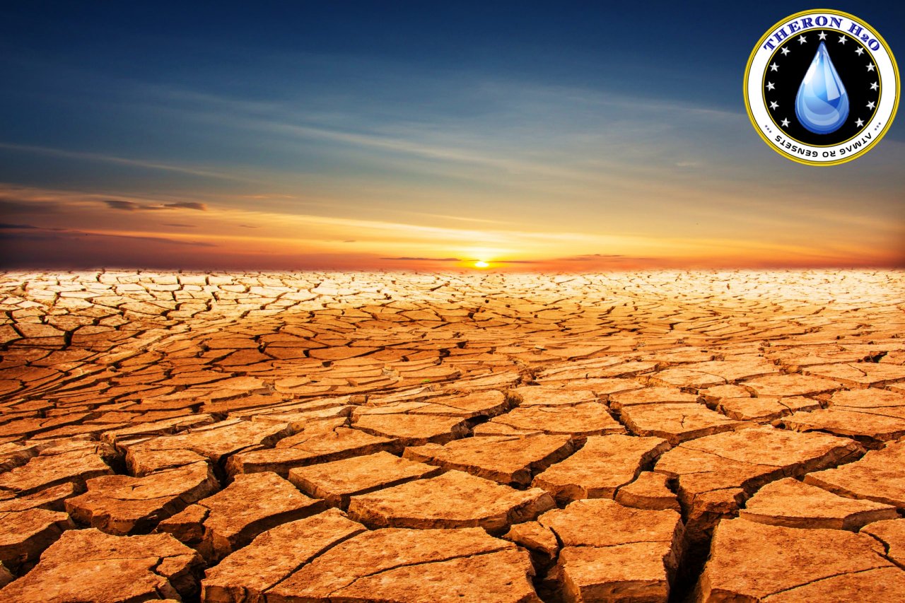 Cracked earth under a sunset sky.